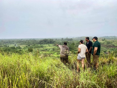 HALO staff members stand on a hill over looking the fields of the bloody ridge