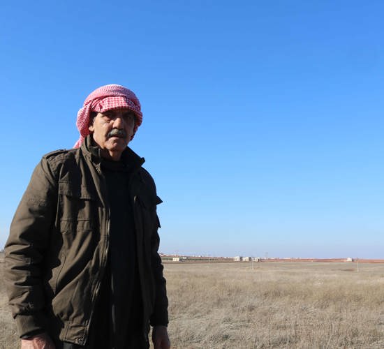 Rami, A Syrian farmer stands Infront of his mined field