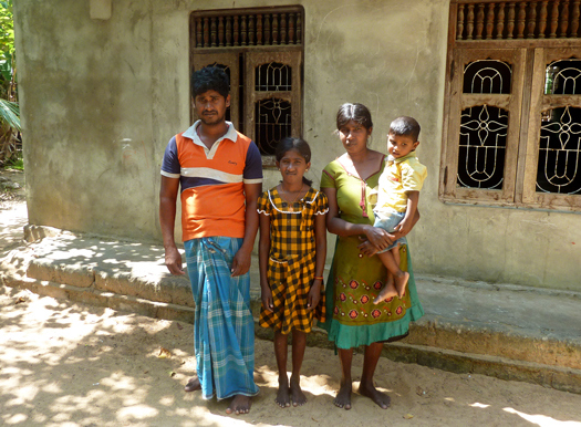 The Ginanasekaram family stand outside their gome