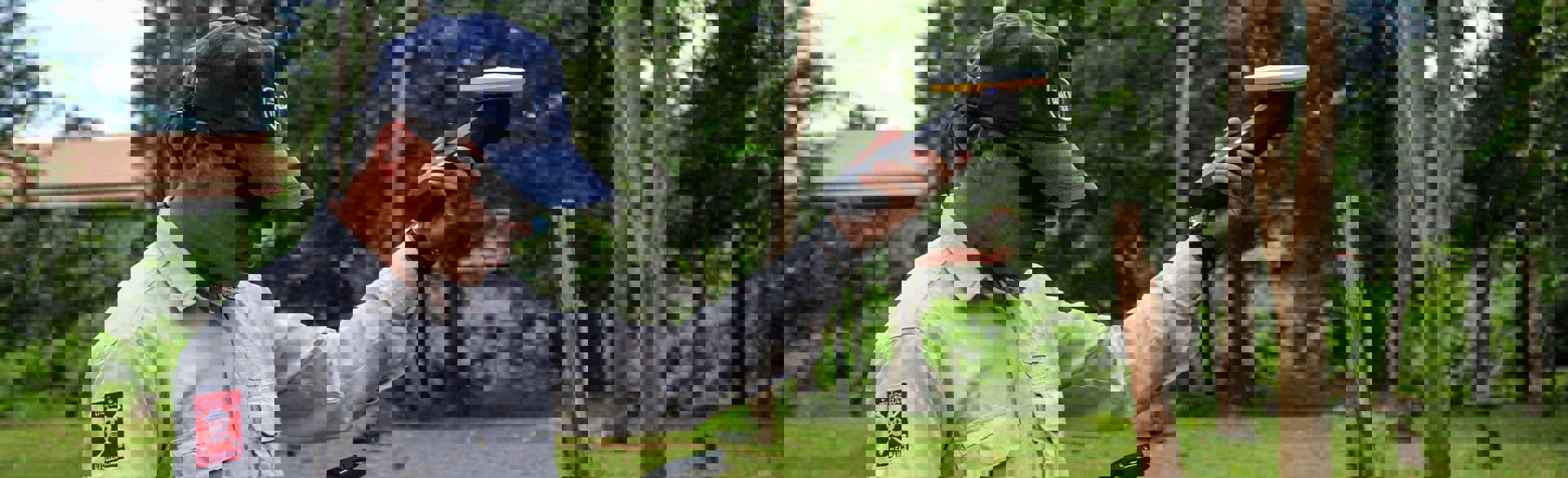 HALO Trust technician using a digital GPS unit to mark the edge of a crater caused by a bomb