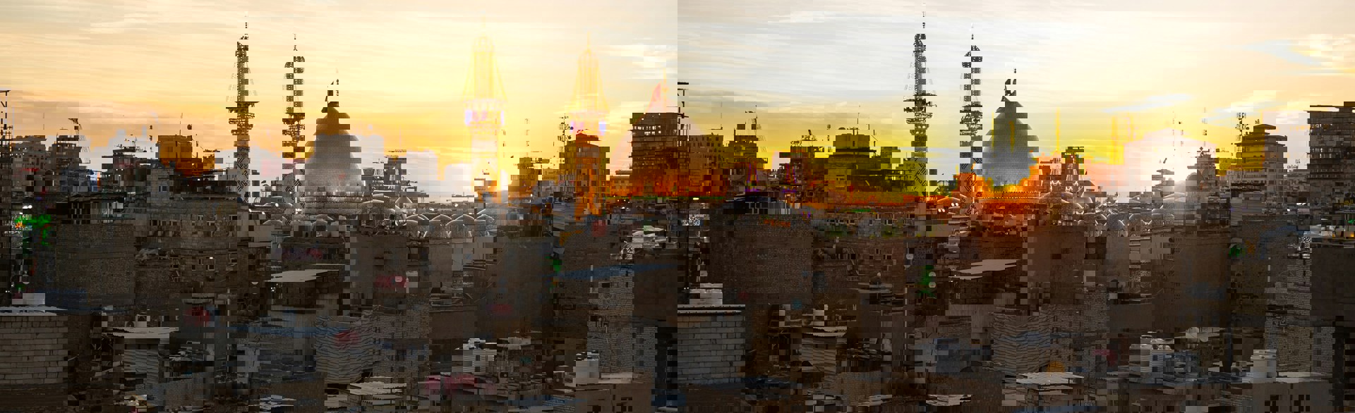 Sunset over rooftops of Iraqi city