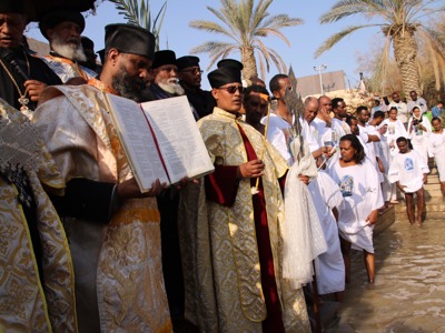 Clergy lead a solemn procession during the epiphany service at the Baptism site, dressed in traditional robes.
