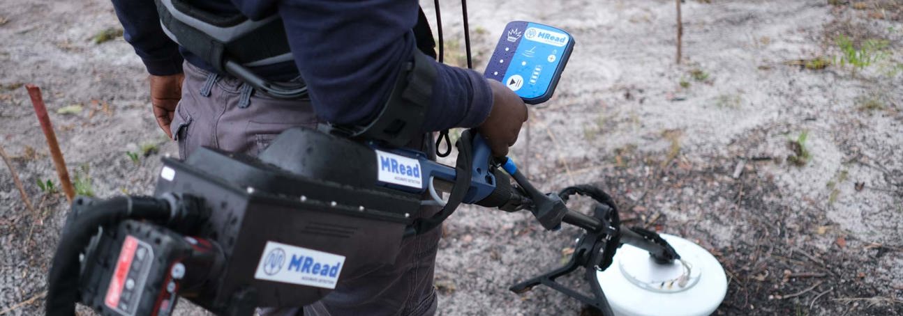 Close up image of a HALO Trust deminer trialling an innovative new detector produced by MRead in a rural minefield in Angola