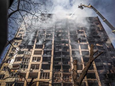 Smoke and flames being extinguished in a large apartment block in Ukraine