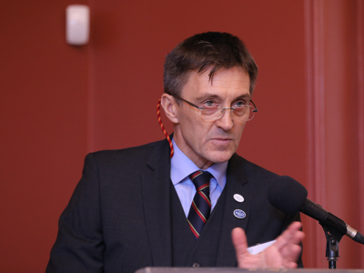 Tim Porter speaks into a microphone on a podium