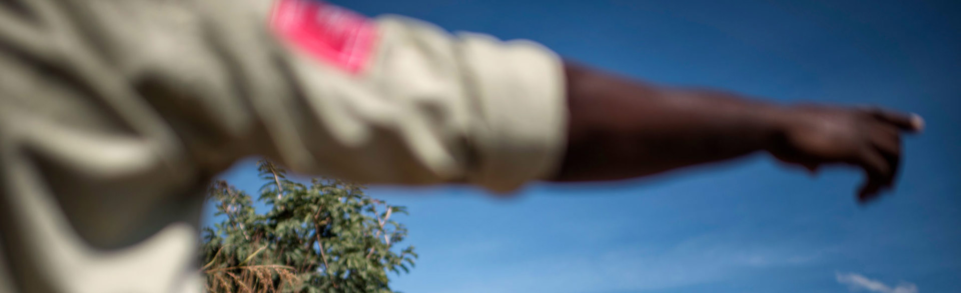 A HALO Trust supervisor in Angola pointing in uniform