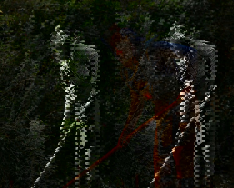 HALO worker wearing a protective vest and visor