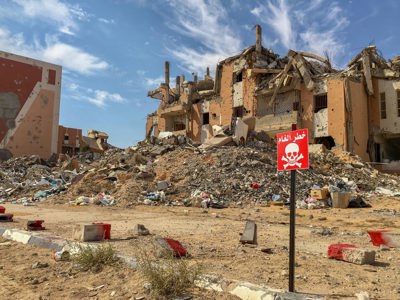A house contaminated with explosives is marked off in Sirte, Libya