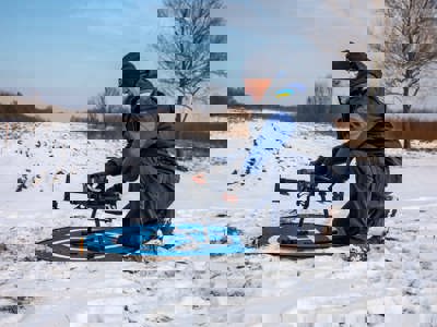 HALO team member setting up a drone in the snow