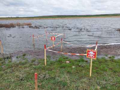 Fenced off landmines and explosive contamination in a flooded field in Kherson Oblast, Ukraine