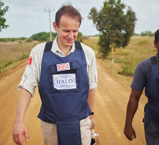 James Cowan, Chief Executive Officer of The HALO Trust, walks with fellow staff member