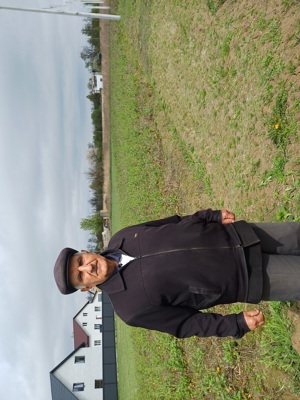 Ivan Ivanovych stands in front of his vegetable garden after HALO landmine clearance operations