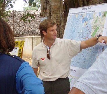Nigel points to a map during an outside briefing
