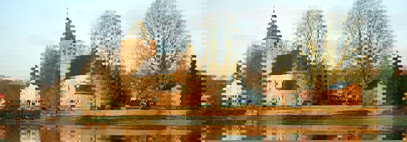 Old church of Oosterbeek, a Battle of Arnhem monument, reflected in the River Rhine