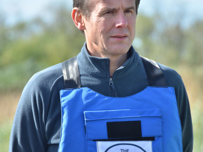 HALO CEO, James Cowan, wearing PPE on a minefield in Ukraine