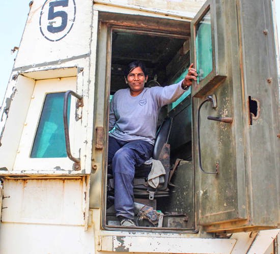 Jeyalalith, a mechanical operator, sits in her machine