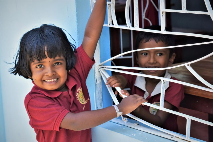 Two children smiling in a school in Sri Lanka